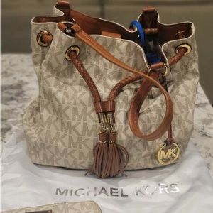 Cream colored MK lettered bag . excellent condition